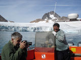 [Photo of boat and glacier]