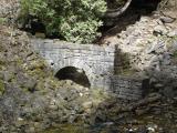 [Photo of an old sawmill's raceway arch]